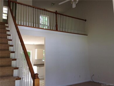 View of living room with the loft area above.