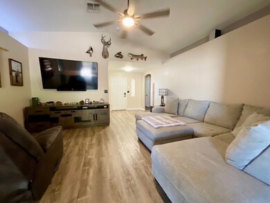 Living area with ceiling fan, vaulted ceiling, lig