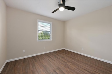 Unfurnished room with dark hardwood / wood-style f