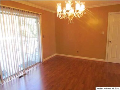 Eat-in kitchen with hardwood flooring and crown mo