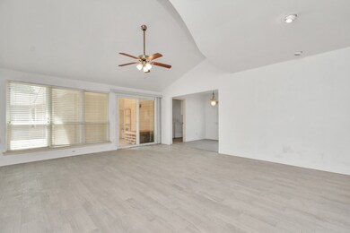 The family room features a wall of windows with fantastic natural light.