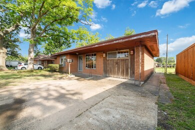 This photo shows a single-story brick home with a