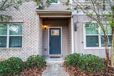 Property entrance with board and batten siding and stone siding