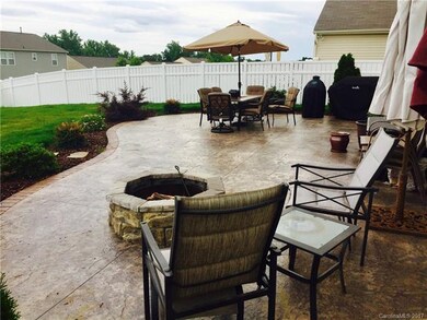 HUGE stamped/dyed concrete patio w/built in fire pit.  Great for entertaining.