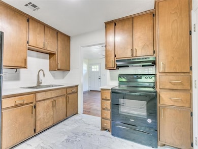 Kitchen with a sink, marble finish floor, visible 