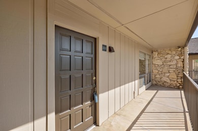 Property entrance featuring stone siding