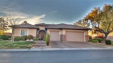 View of front of property with stucco siding, a ga