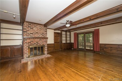 Family Room with built-in cabinets and door to dec