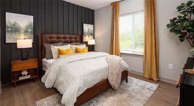 Bedroom with wood finished floors and baseboards