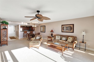 Living room with light carpet and ceiling fan with