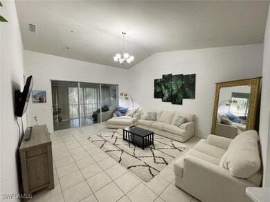 Living room with light tile patterned flooring, lo