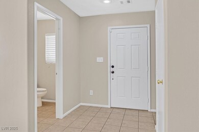 Foyer entrance featuring light tile patterned floo