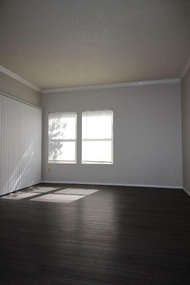 Unfurnished room featuring baseboards, crown mold