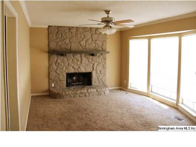 den with bay window and wood burning fireplace.