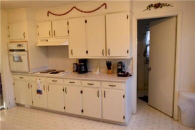 Pantry and half bath located off the kitchen.