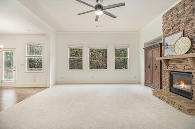 Unfurnished living room featuring crown molding, v
