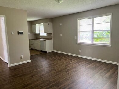 Unfurnished living room with a textured ceiling, d