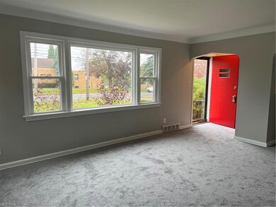 Foyer w/coat closet and new carpet, living room.