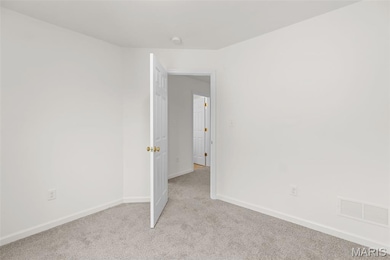 Carpeted empty room featuring baseboards