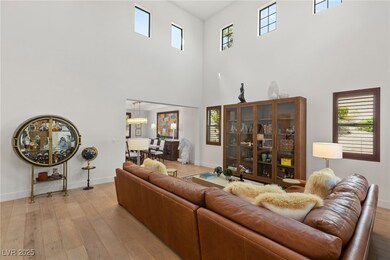 Great room with soaring ceilings, wood flooring an