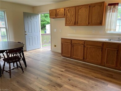 Kitchen leading to the deck - fresh paint and new flooring