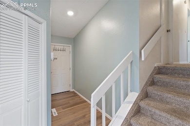 Entry way with stairway featuring wood finished floors and a textured ceiling