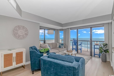 Living room with baseboards, visible vents, a wate