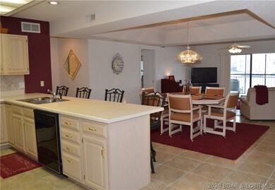 Open floor plan from kitchen, dining, and living room and access to huge screened porch