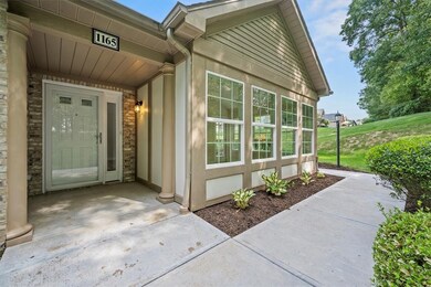 The front features a covered entry with sidelight