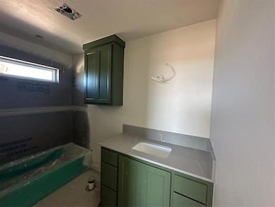 Full bathroom with a garden tub and vanity