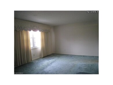 Living room.  Oak flooring is under the wall to wall carpeting.