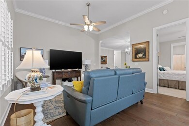 Living room with ceiling fan, wood finished floors