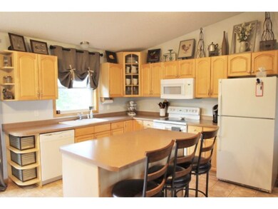 The kitchen has maple cabinets, ceramic tile floor