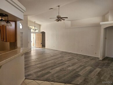 Unfurnished living room featuring ceiling fan with