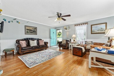 Living room with ceiling fan, light hardwood / woo