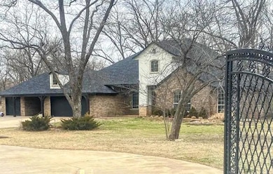 View of front of home with a front lawn, driveway, a garage, and roof with shingles