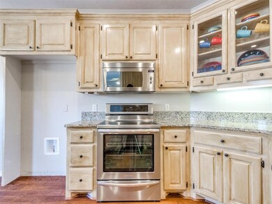 Kitchen featuring stainless steel appliances, glas