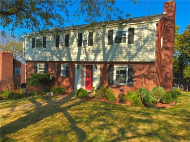 Beautiful landscaping and a large yard and deck ar