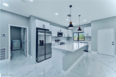 Kitchen featuring marble finish floor, washer / cl