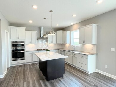 Photos is of a different, sold home. Options, finishes and colors vary. Who wouldn't love this bright, beautiful gourmet kitchen. Look at all of that lighting! LEDs, pendants, AND undercabinet lighting.