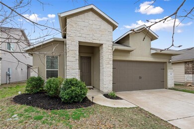 View of front of property with stucco siding, concrete driveway, an attached garage, and stone siding