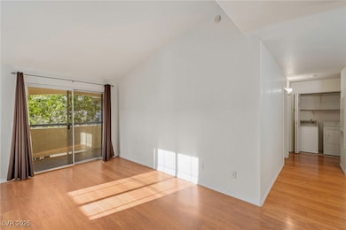 Empty room with washing machine and dryer, light w