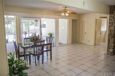 A massive family room/dining room with that clean look of the white tile.