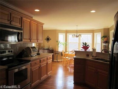 Kitchen. Gorgeous kitchen with wood floors, stainless appliances, and some glass fronted cabinets