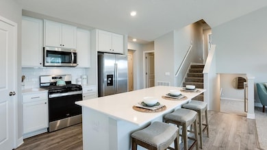 Extremely open and inviting, this main level is great for hosting or hanging out! Also, you can see the convenient main level bathroom nearby. Photo of Model Home. Options and colors may vary. Ask Sales Agent for details.