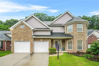 Traditional home with concrete driveway, a front y