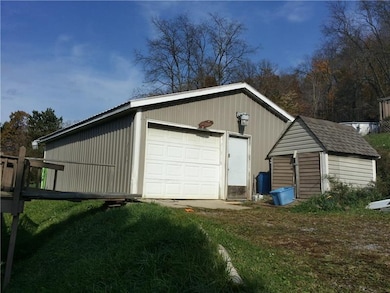 Garage with storage shed.