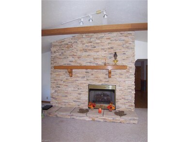 The floor to ceiling stone fireplace is the focal 