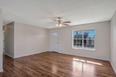 Check out this great living room!  Lots of natural light, a ceiling fan, and more!