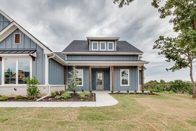 View of front of home with board and batten siding, a front lawn, and a shingled roof
